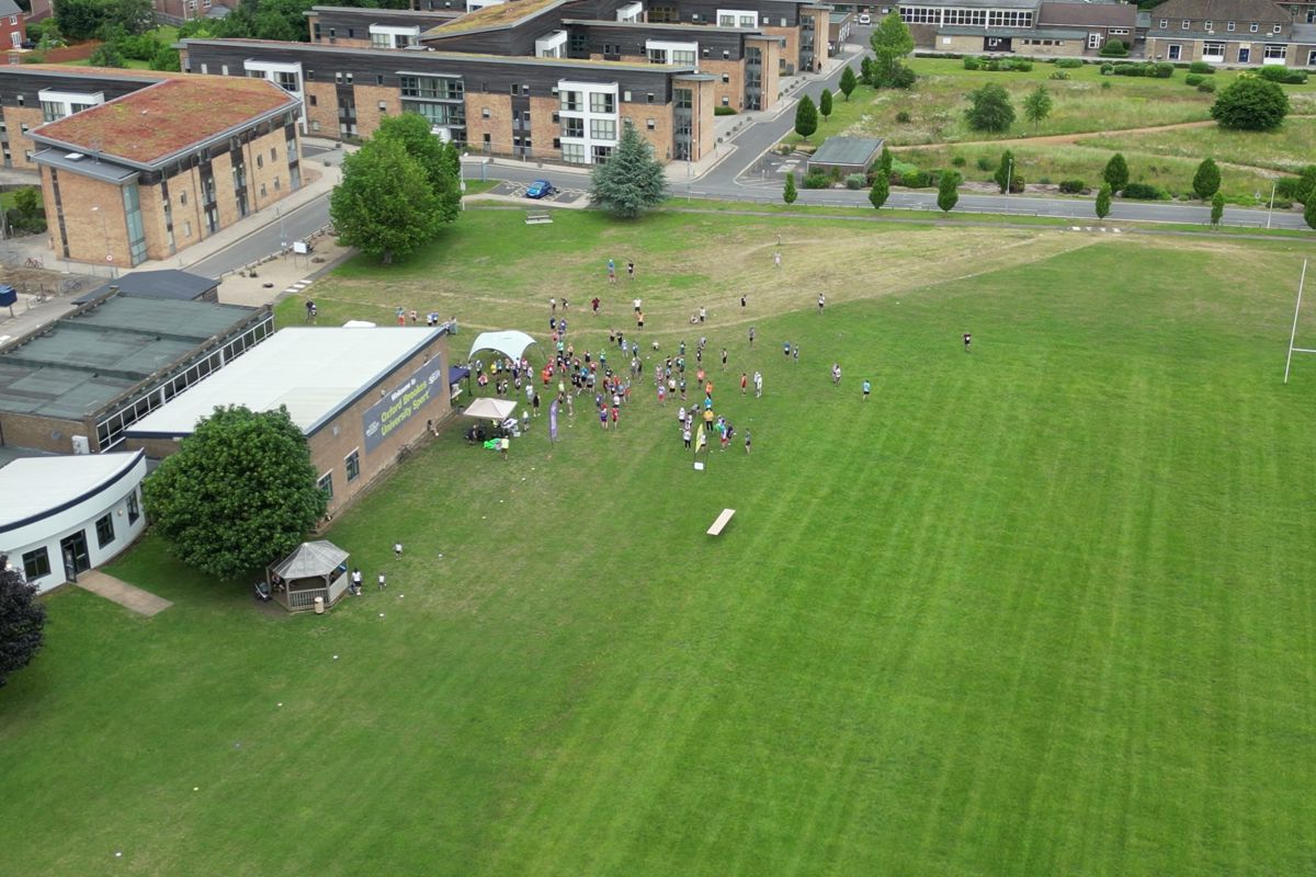 The start area from above, runners spread across the grass