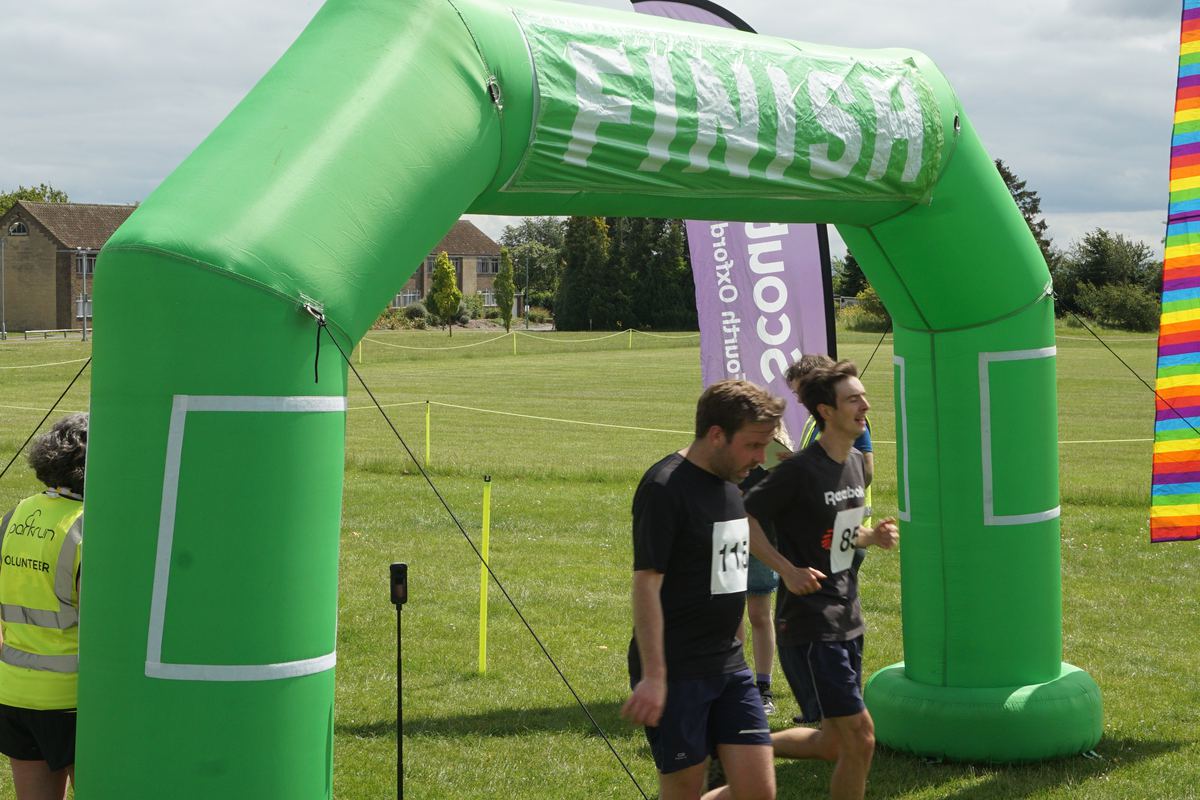 Two runners crossing the finish line side by side